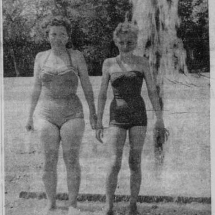 First In!, 1958, Selkirk Enterprise Black and white newspaper clipping of image of two women standing infront of a fountain