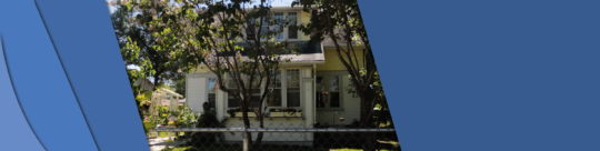 212 Mclean Photo shows the front of Gibbs House with trees in front of the house.