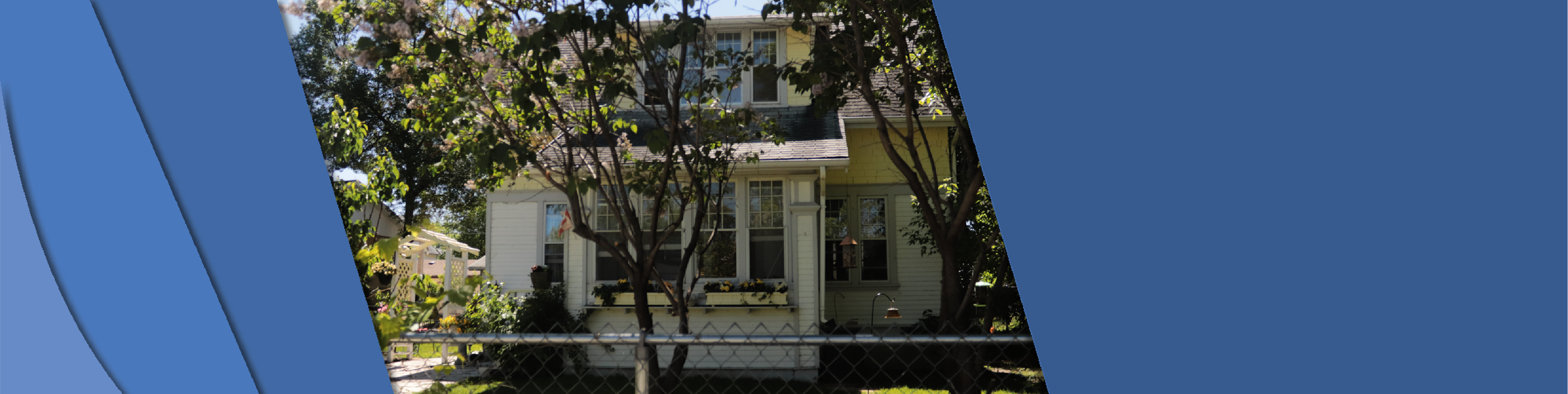 Photo shows the front of Gibbs House with trees in front of the house.