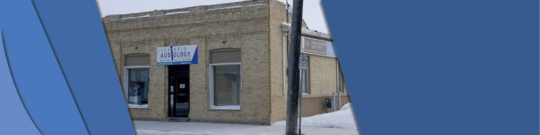 This photo shows off the single level building with a front entrance with two windows on either side