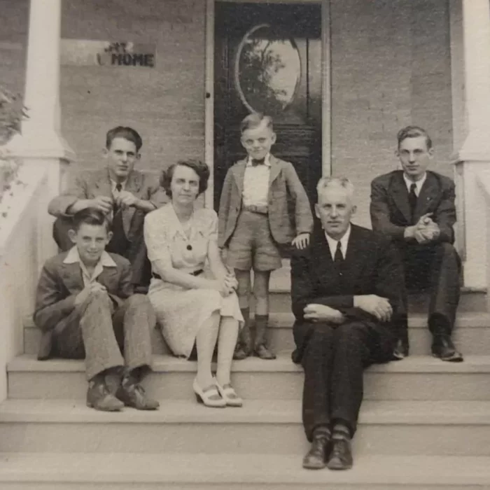 Maurice and Muriel Gilbart and their Four Boys, Mel top left, Eric top right, Don middle, Roy bottom left, c1942, Wes Gilbart Black and white photo of a family sitting on their front steps