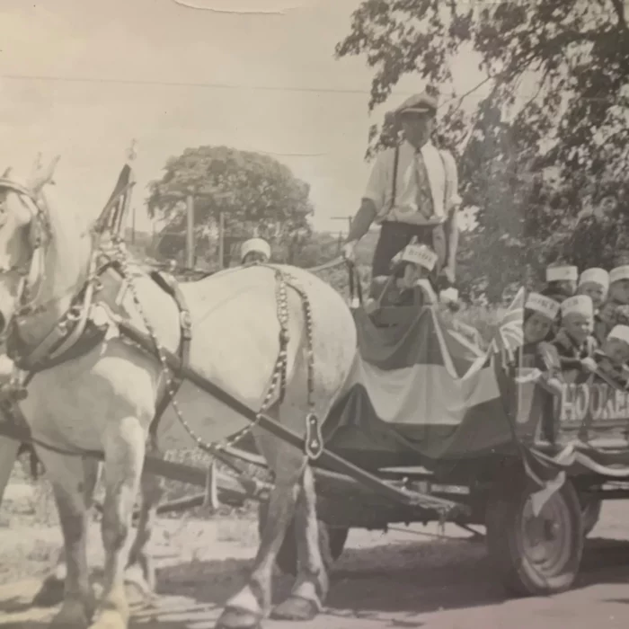 Lawrence Slater Drives Hooker Wagon, c1953, Joen Hadfield A parade float pulled by two white horses