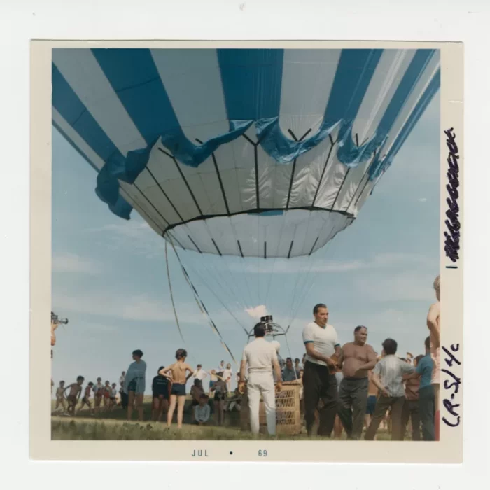 People waiting for the large blue hot air balloon