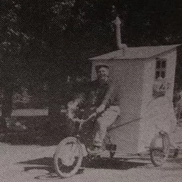 Bunny Cooper Takes Part in the Fair Parade, 1966, Selkirk Enterprise Centennial Edition Black and white portrait of a man riding his bicycle with a float attached