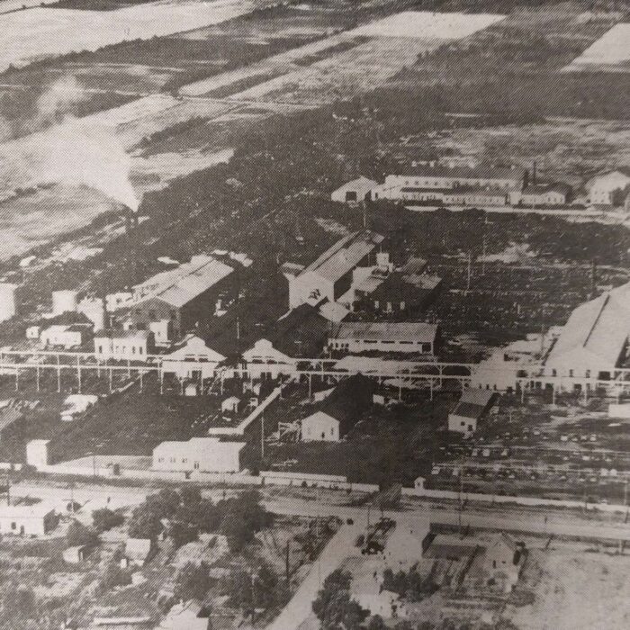 Aerial View of the Manitoba Rolling Mills with Farm Land in the Background, c1950s, Selkirk Enterprise Centennial Edition, Aerial view of Manitoba Rolling Mills in black and white