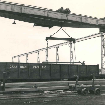 Shipping Product Now Transported by Trucking Industy As Well As Rail Industry, Date Unknown, Gerdau Canadian Pacific train car passing through Gerdau