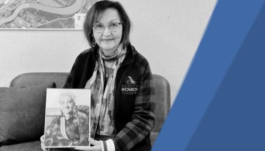 Black and white picture of Marcella-Vezina holding a photo of Elsie Bear