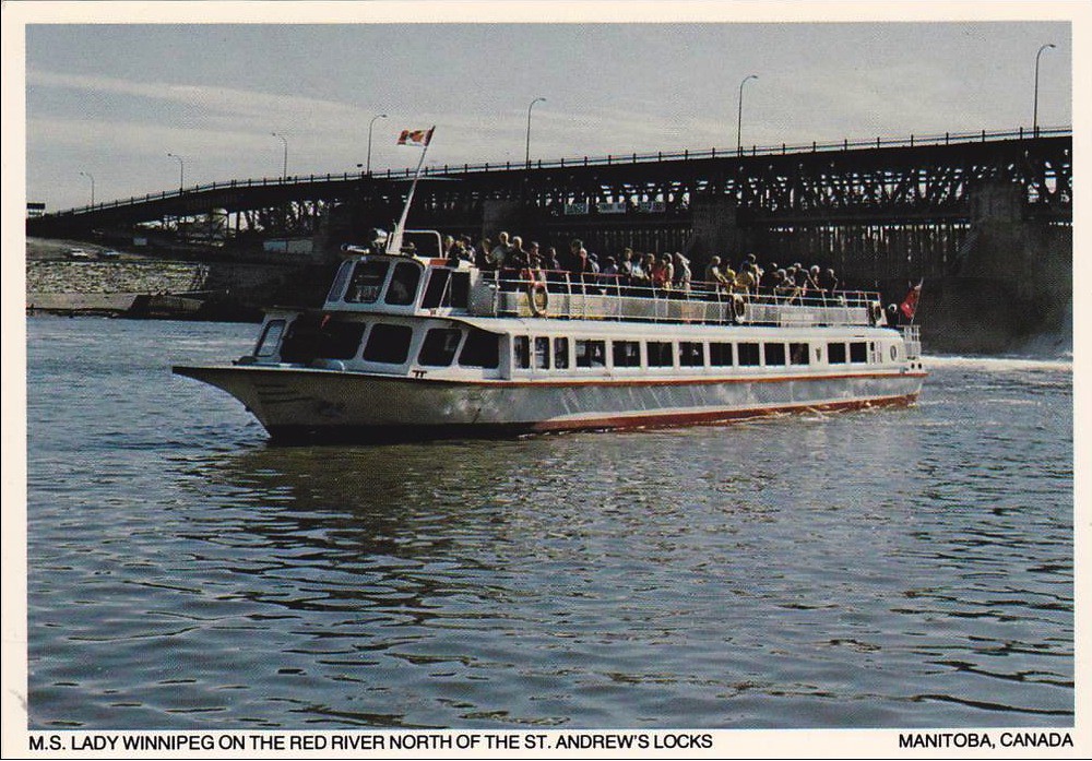 Colour image of boat on water, with people standing on the deck.