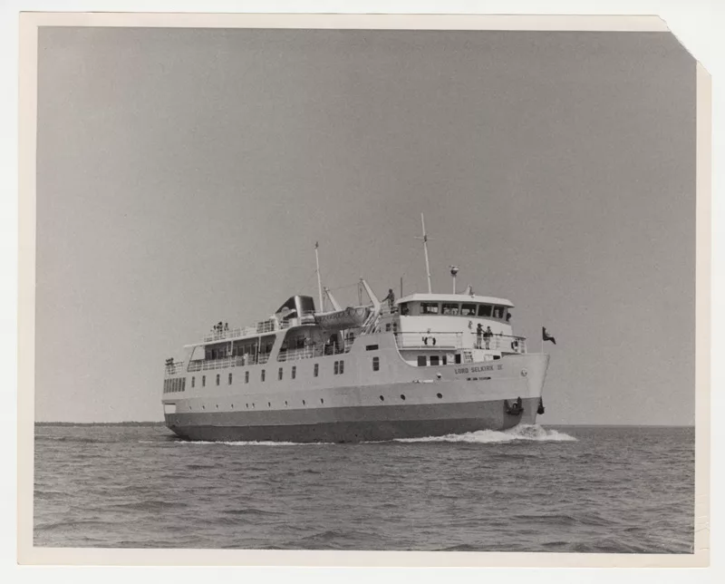 Black and white photo of a large boat on water