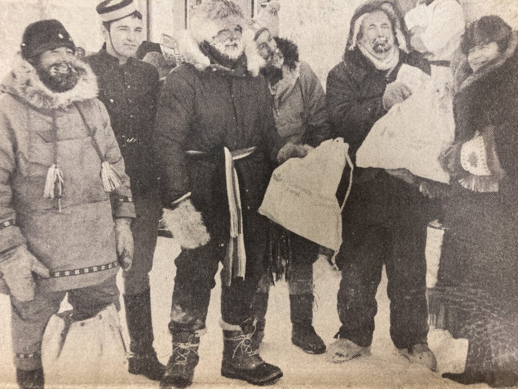 Group of men shown in winter garments smiling