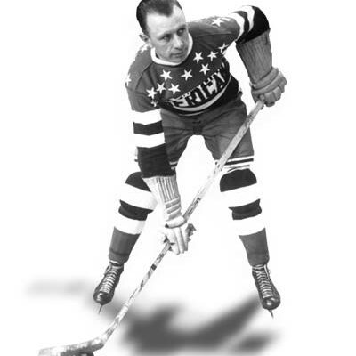Black and white photo of Harry Oliver posing with his hockey stick