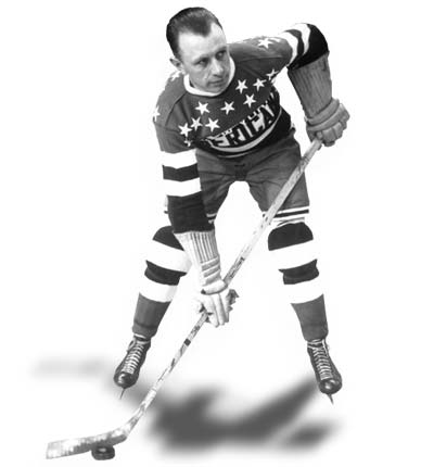 Black and white photo of Harry Oliver posing with his hockey stick
