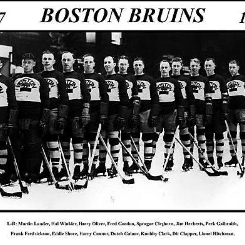 Black and white photo of the Boston Bruins standing on ice surface