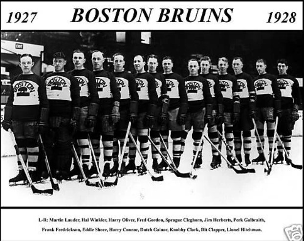 Black and white photo of the Boston Bruins standing on ice surface