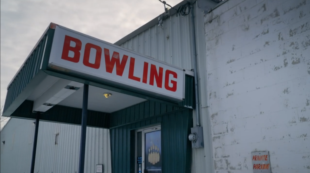 Image of Selkirk Bowling Alley. A big sign with the word 'Bowling' in bright red letters hangs above the door