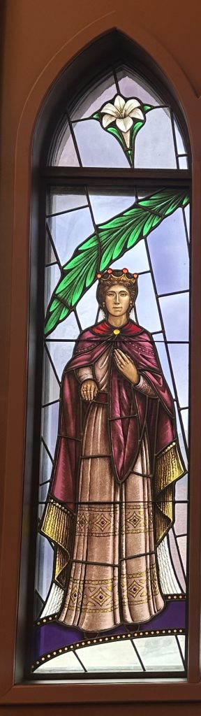 Esther wears a red cape with a red robe and a crown