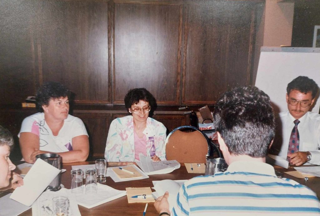 Pat Croy and Lori Weatherby on Left siting at a table with papers in front of them