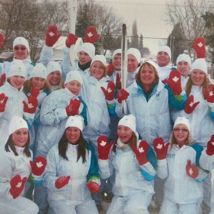 Selkirk Community Pool and Selkirk Dolphins Run the Olympic Torch, 2010, Michelle Stamm Selkirk Community Pool and Selkirk Dolphins Run the Olympic Torch posing as a group with the torch held in the center of them