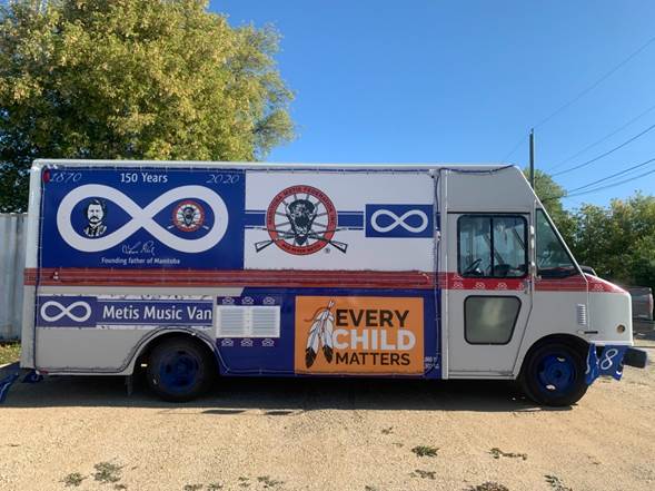 The Metis Music Van with cultural  symbols and an "Every child Matters" poster and messages like "150 years"