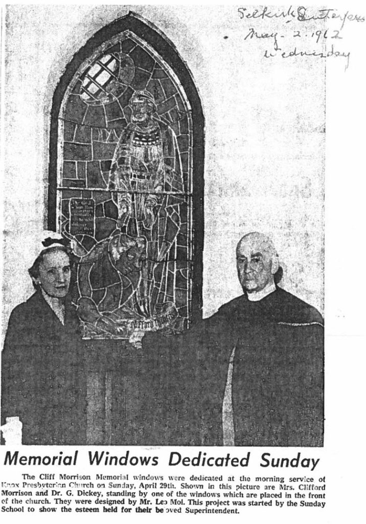 Mrs. Clifford Morrison and Dr. G. Dickey standing by one of the windows in the church