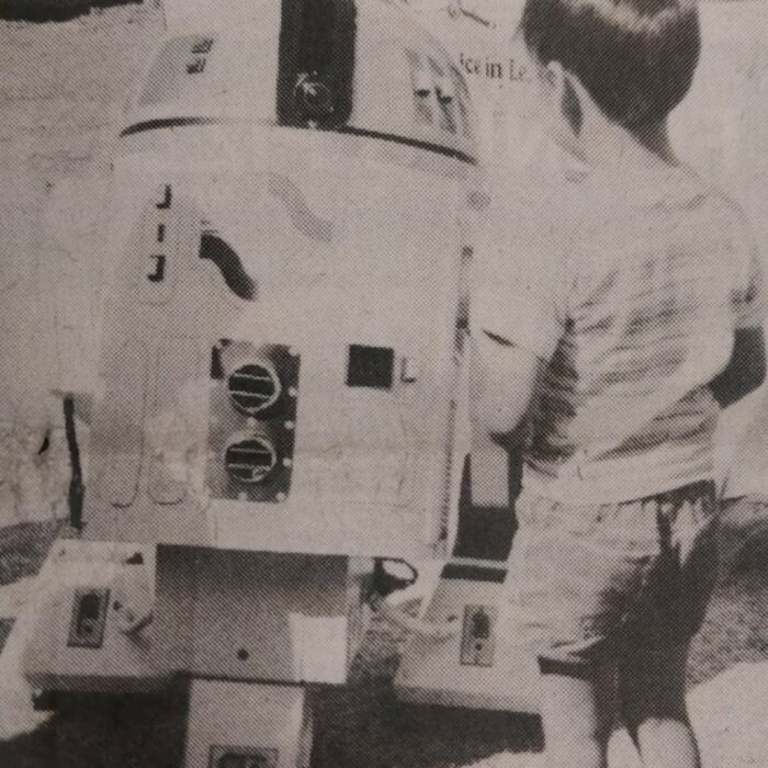 Everett with Grant Hoban's Robot SC100, 1982, Selkirk Enterprise Black and white image of a young boy next to the Centennial robot