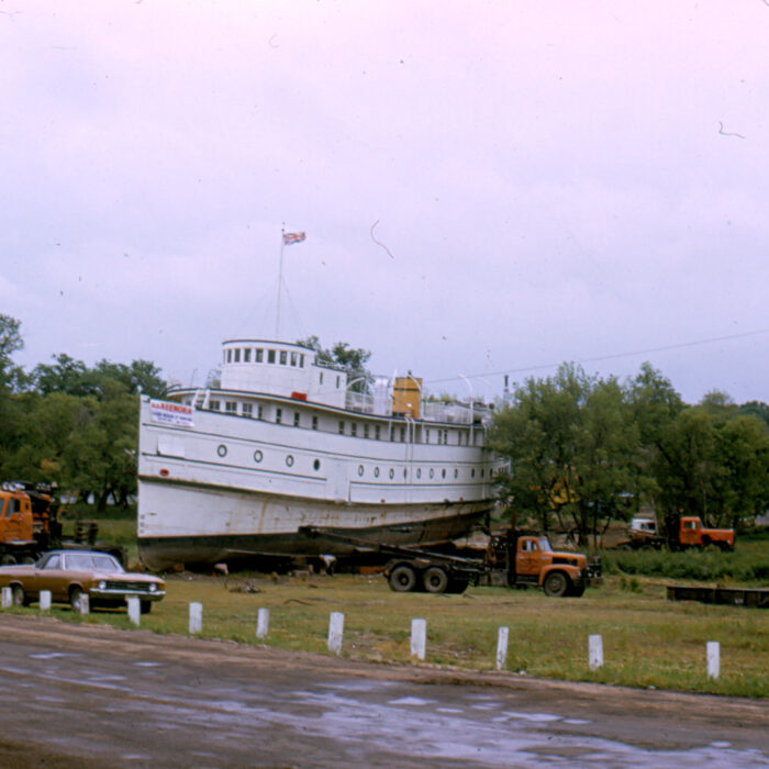 Keenora Arrives at Museum Site, 1973, Selkirk Museum Collection Colour photograph of the Marine Museum when the Keenora Arrived. The road at the forefront of the image is muddy and the sky overcast