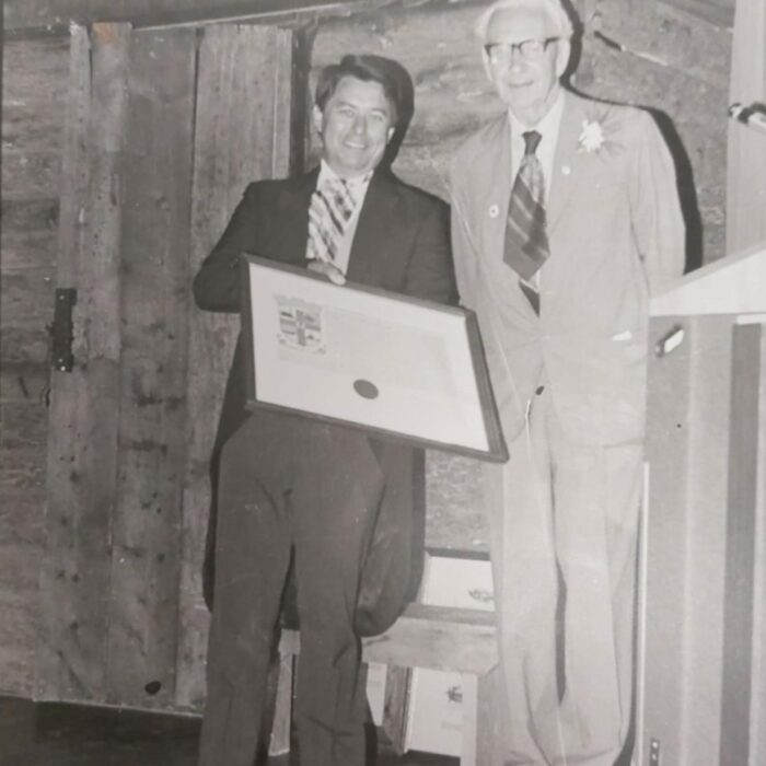 Mayor Bill Shead and the Earl of Selkirk with the Selkirk Coat of Arms, 1982, Selkirk Museum Collection Black and white image of Mayor Bill Shead and the Earl of Selkirk posing together. Mayor Bill Shead holds the Selkirk Coat of Arms