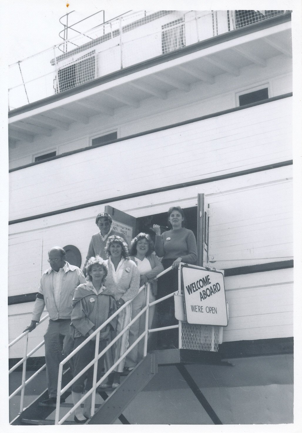 Black and white image of the Keenora on opening day. People stand on the staircase leading up to the door.