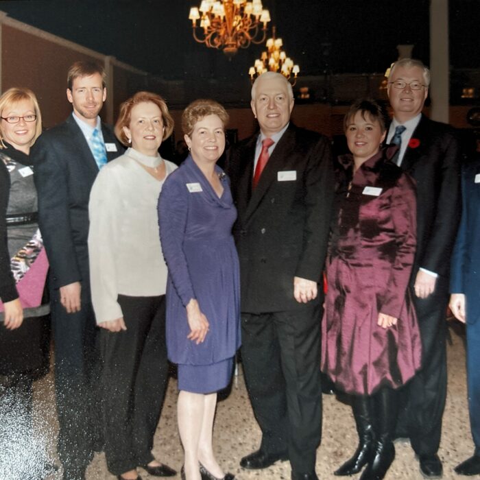 Bill Bodman, Bev Clegg, Mark Webster, Bev Stewart, Ruth Konzelman, Frank Wellink, Kelly Lewis, Rick Frost, Michael Buhr, Shirly Muir, 2012, Selkirk District Community Foundation A group of people stand together in a dimly lit room. They are dressed up and at an event