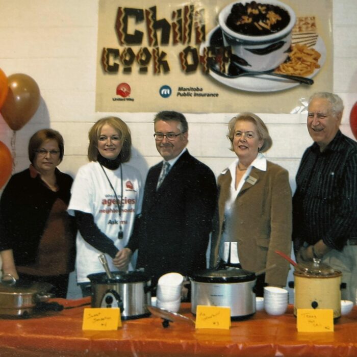 Chili Cook Off Judges Connie Rapko, Michael Buhr, Bev Strewart, Joe Smolinski, 2009, Selkirk District Community Foundation A group of people stand behind a table. On the table are crock pots of chili.