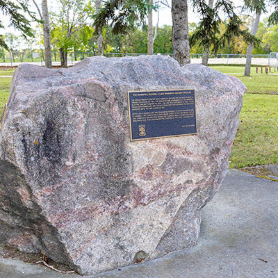 Colour image of stone monument with a black and gold plaque