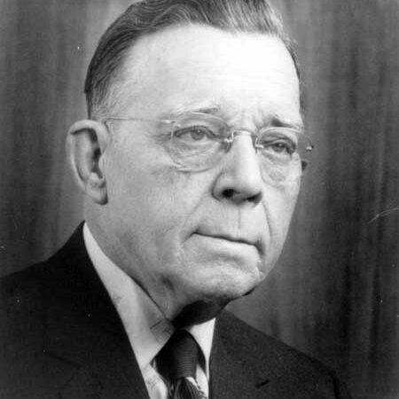 Thomas Sill, Date Unknown, Thomas Sill Foundation Black and white image of a man looking to the right. He is elderly and wears think framed glasses. He is wearing a black suit jacket, white shirt, and a black tie. He has short hair
