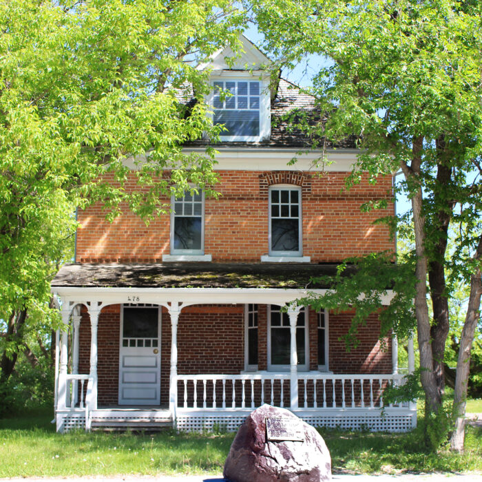 478 Eveline St, 2020, Selkirk Museum Collection Colour image of a orange brick house. The house is three storeys and has a white verandah and white trim. The house has symmetrical windows