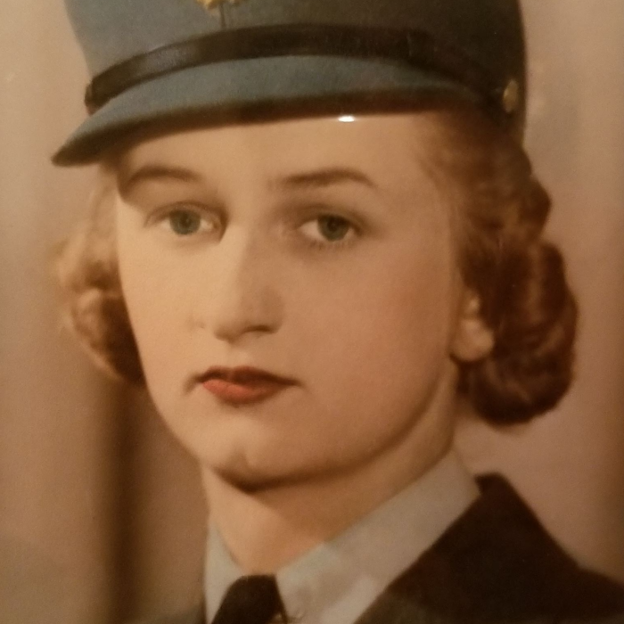 Beatrice Gunter, 1943-1945, Krewiak Family Colour image of Beatrice Gunter. She looks past the camera and wears a shirt, tie, and jacket. Her hair is pinned up and she wears a blue hat