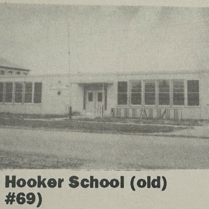 Black and white photo of Hooker School. The school is one story, long and rectangular