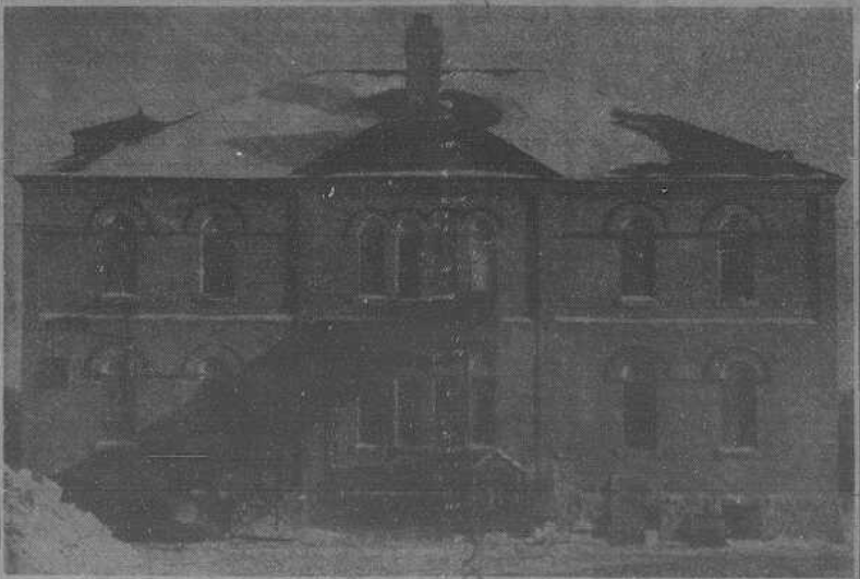 A black and white underexposed image of a three story school house