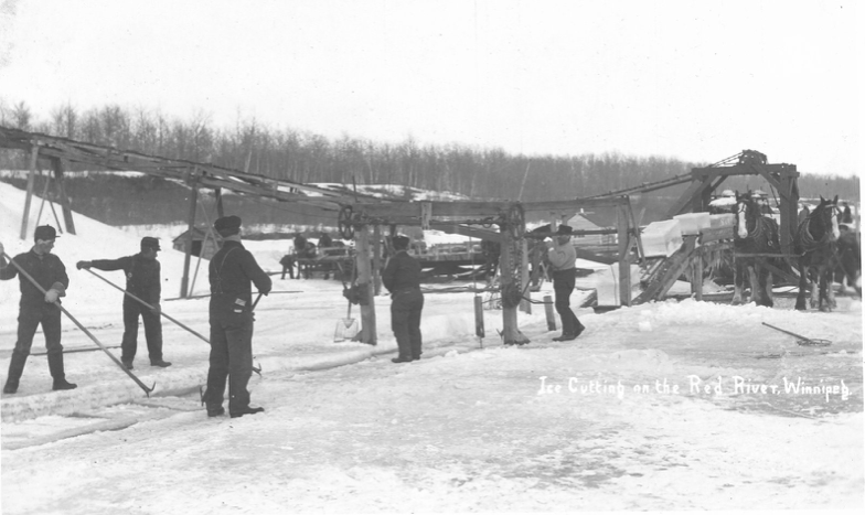 A black and white image of men standing on the frozen river. The men are cutting ice
