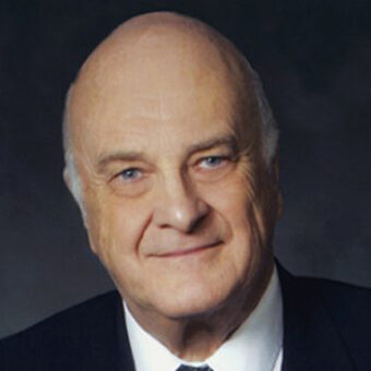 Howard Pawley, c2011, University of Winnipeg Colour photo of Howard Pawley as an older man. He smiles at the camera and is wearing a suit and tie