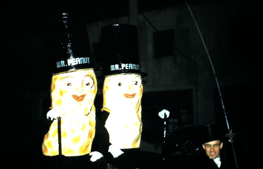 Colour photo of two people dressed up as peanut men