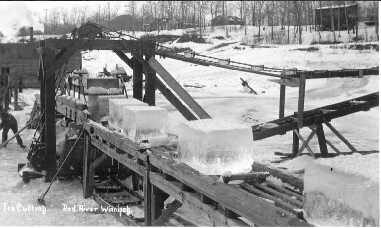 A black and white image of several large ice blocks on a conveyor ramp.