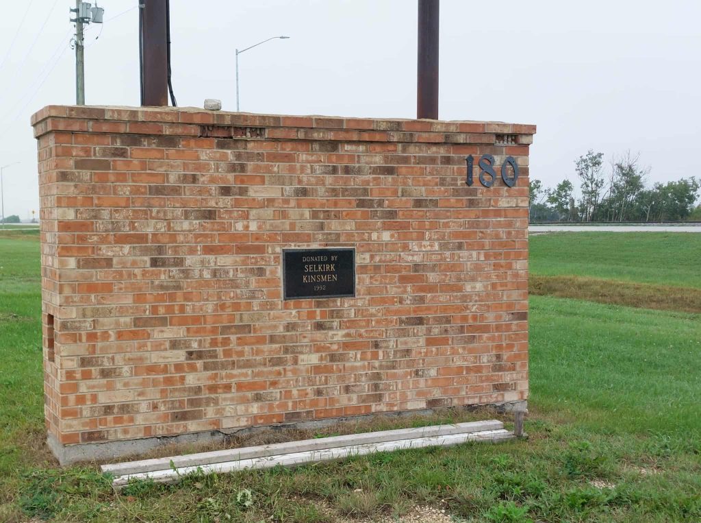 Colour photo of a brick wall with a small plaque on it