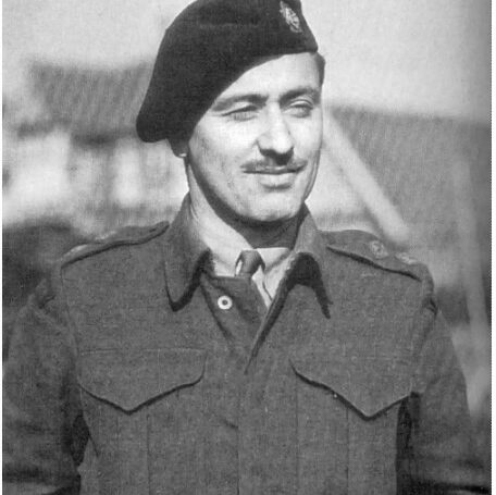 Bill Little, c1939-1944, Winnipeg Free Press Black and white photo of a soldier in uniform. He wears a black hat, a moustache, and a tie. He looks to the right and smiles