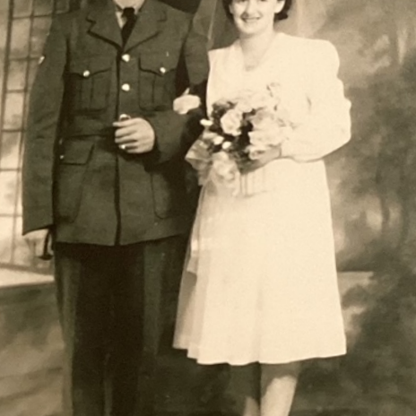 Harold and Margurite Wedding Photo, c1942, Icelandic Collection, Elizabeth Dafoe Library, University of Manitoba Black and white image of a bride and groom. The groom is wearing a military uniform and the bride is wearing a tea length white wedding dress. She holds flowers and the arm of her husband
