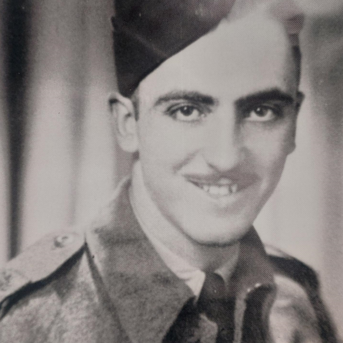 James (Jim) Laye, 1939-1945, Laye Family Black and white photograph of Jim Laye. He is dressed in military uniform and looks at the camera. He has a moustache and smiles.