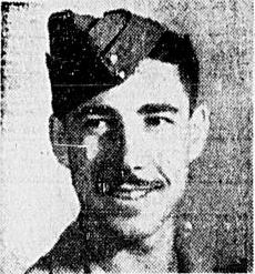 Black and white image of a young man in military uniform. He looks to the left of the camera and smiles