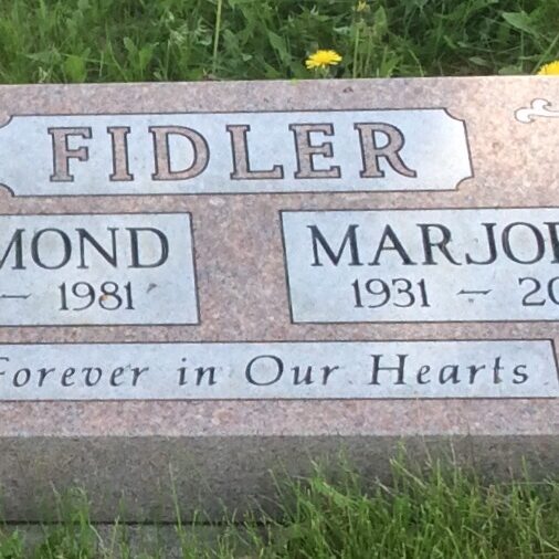 Raymond Fidler Gravestone, 2014, Find A Grave A colour image of a gravestone. The gravestone is red with black lettering outlined with white boxes