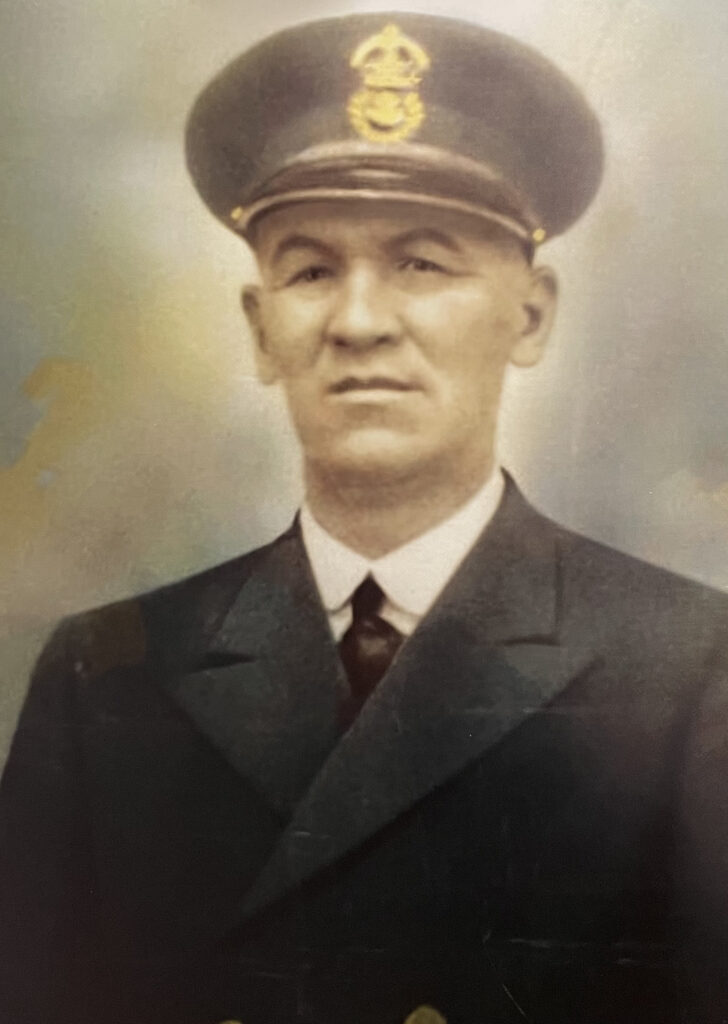 Colour photo of a painting of a man in military uniform. He looks at the camera