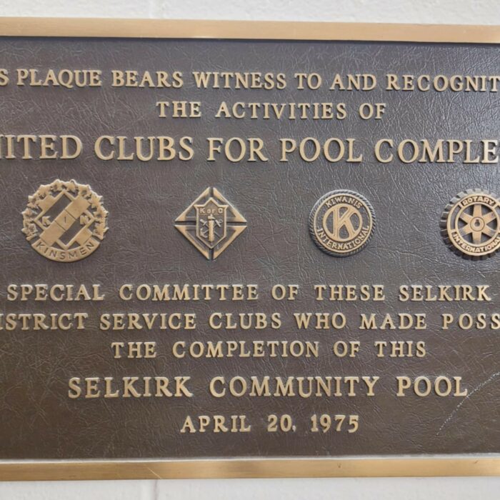 A colour image of a metal plaque detailing the service groups who assisted with the construction of the Selkirk Community Pool