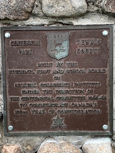 Colour image of a metal plaque on a cairn