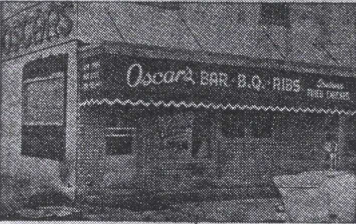 Black and white photo of Oscar's Restaurant. The building has an awning with the words 'Oscar's Bar B. Q. Ribs'